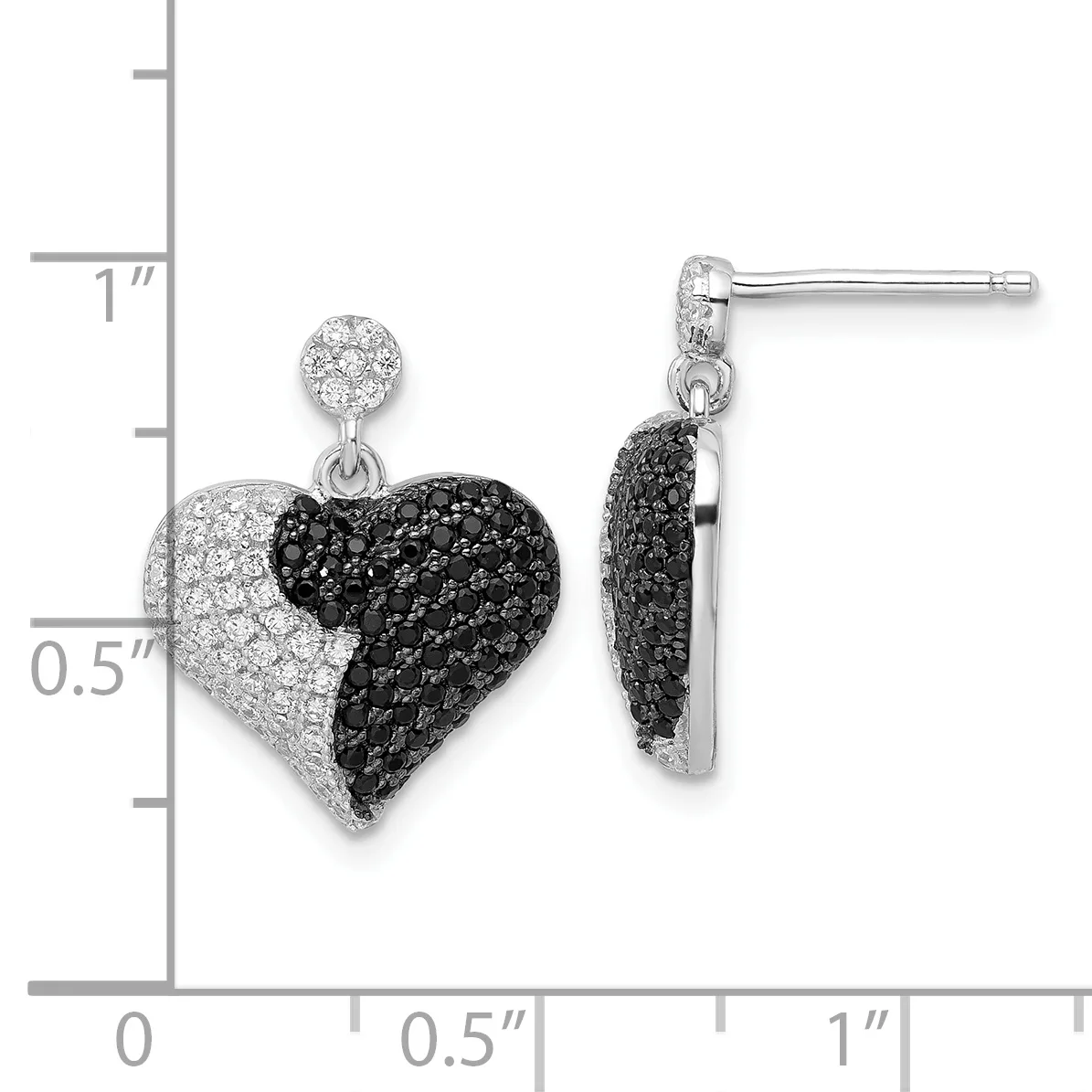 A pair of heart-shaped drop earrings with black and white crystal pave, displayed next to a measurement scale showing approximately one inch in length.