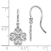 A pair of silver four-lobed clover earrings with diamond accents and curved wire hooks, displayed against a measurement scale showing approximately one inch in length.