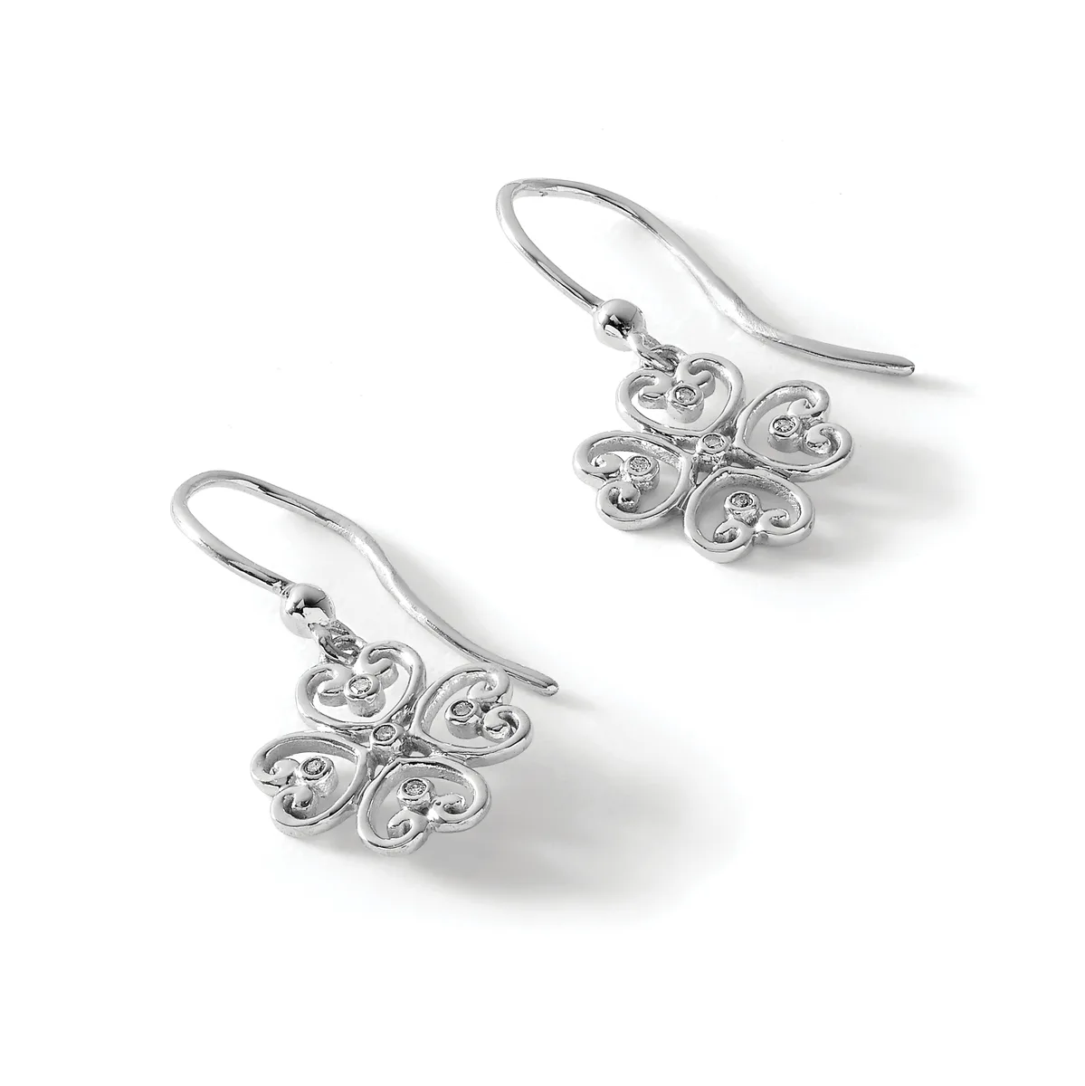 A pair of silver drop earrings with ornate four-lobed clover-shaped pendants featuring small diamond accents, suspended from curved wire hooks.