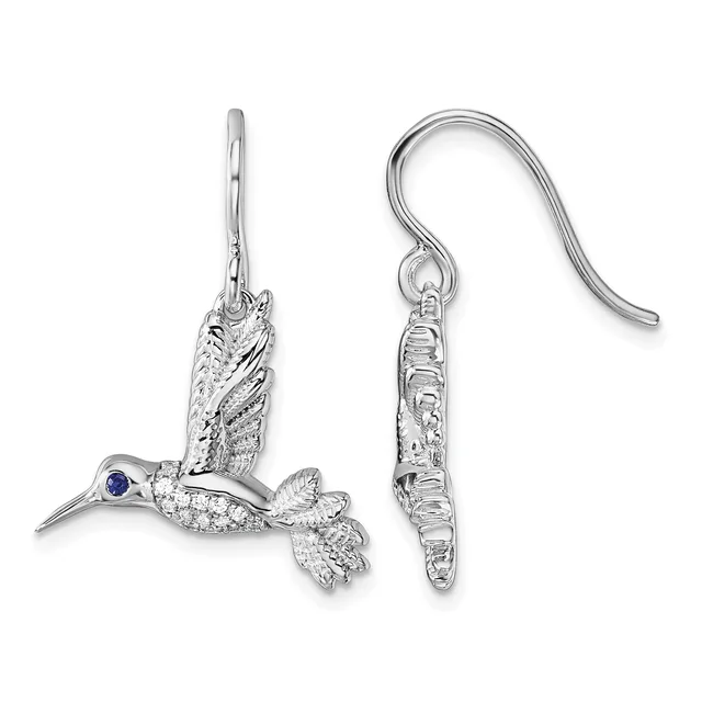 A pair of silver hummingbird dangle earrings with textured wings, sapphire eyes, and curved ear wires displayed side by side.