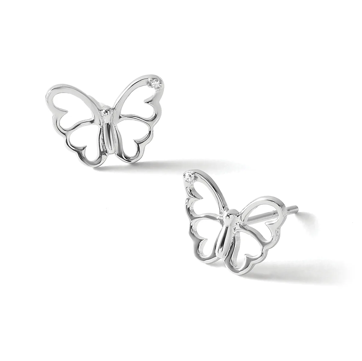 A pair of silver butterfly stud earrings with open wing designs and small diamond accents, shown from two angles against a white background.