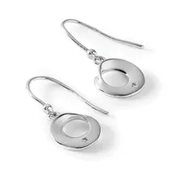 A pair of silver-toned drop earrings with circular disc pendants featuring small diamond accents, suspended from curved wire hooks.