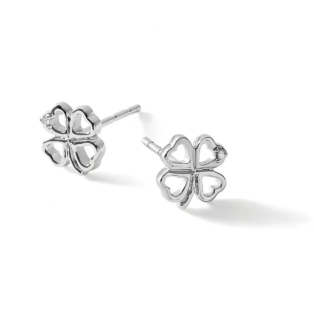 A pair of silver four-leaf clover stud earrings with hollow heart-shaped petals and small diamond accents, shown from two angles on a white background.