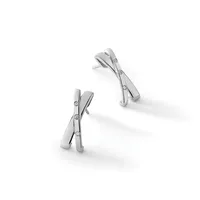 Two silver crossover earrings with small round diamond accents, displayed at angles on a white surface.