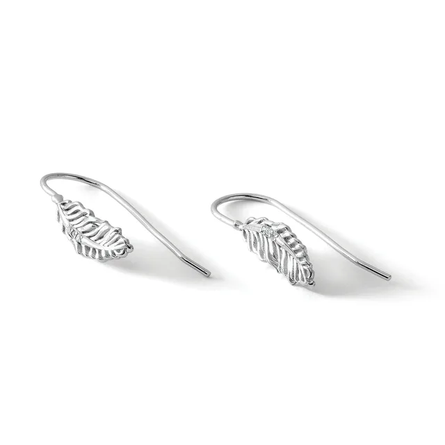 A pair of silver leaf-shaped drop earrings with curved wire hooks, displayed at an angle against a white background.