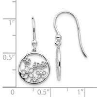 Silver drop earrings with circular pendant frames containing openwork floral designs, displayed against a ruler showing approximately one inch in length.