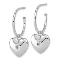 Pair of silver hoop earrings with heart-shaped charms featuring small diamond accents, shown hanging against a white background.