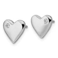 A pair of polished silver heart-shaped stud earrings, each decorated with a small round diamond, displayed against a white background.