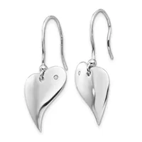 A pair of silver heart-shaped drop earrings with long curved hooks, each heart featuring a small diamond and a polished finish.