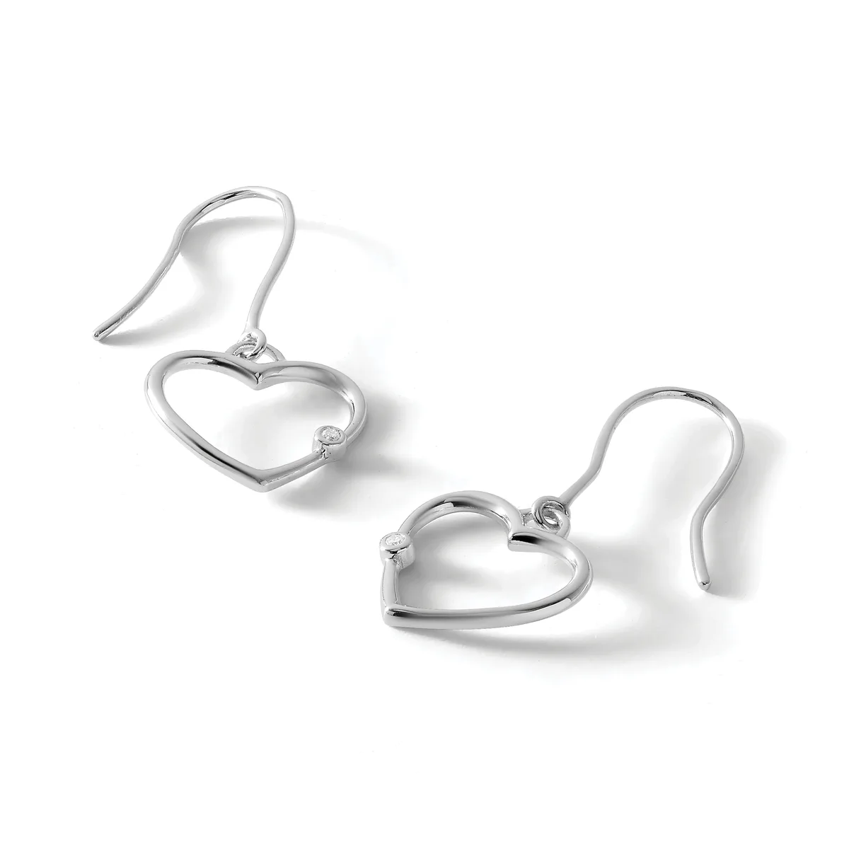 A pair of silver heart-shaped dangle earrings with curved fish hook ear wires, displayed against a white background.