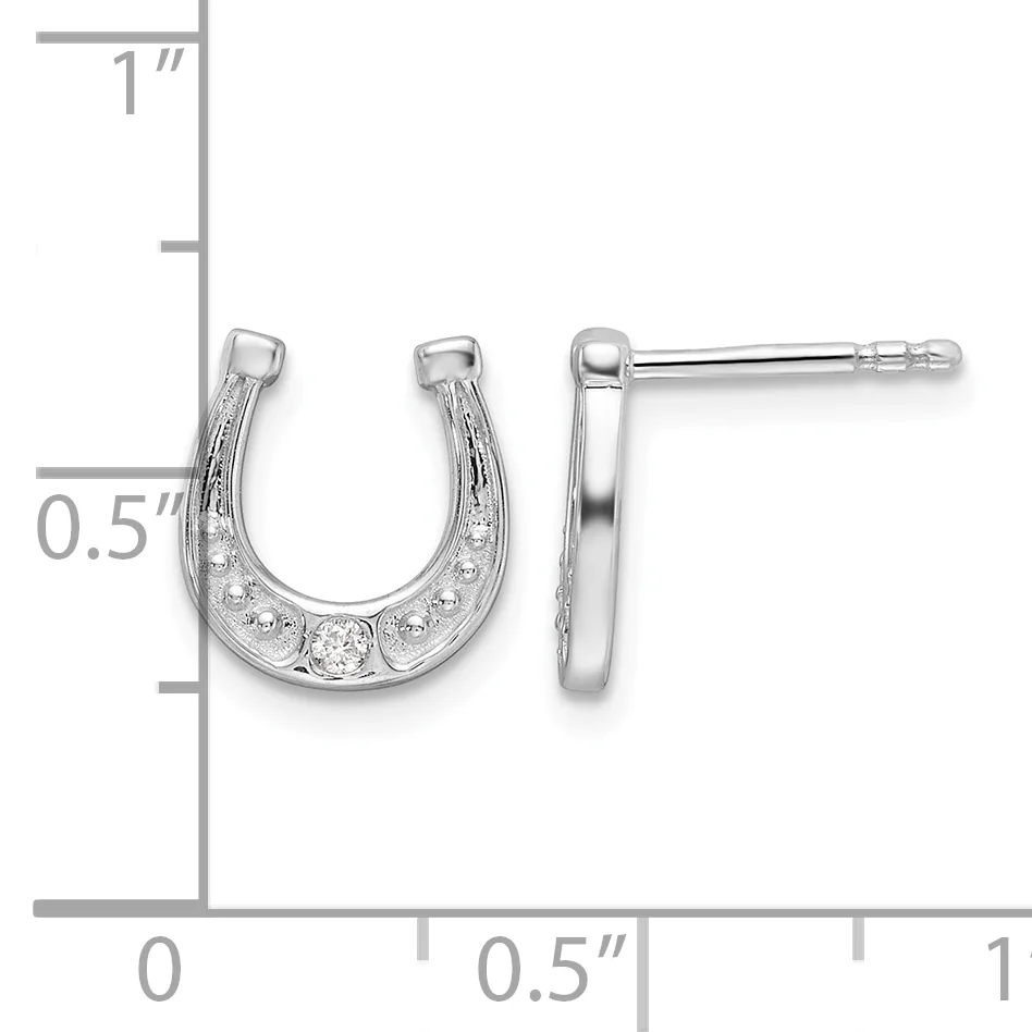 A pair of silver horseshoe-shaped stud earrings with cubic zirconia stones set along the curved surface, displayed against a measurement scale showing approximately 0.5 inches in height.