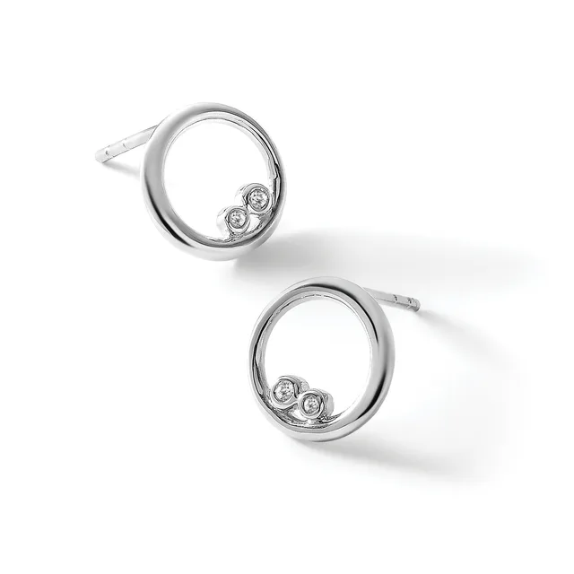 A pair of silver circular stud earrings with two small bezel-set diamonds positioned inside each ring, shown at slight angles against a white background.