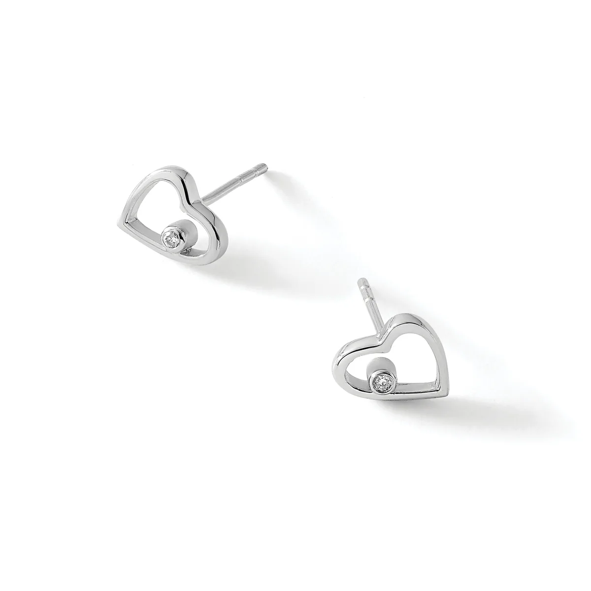 A pair of silver heart-shaped stud earrings with small diamond centers, displayed against a white background.