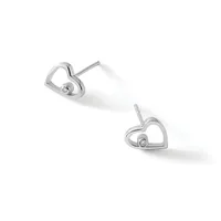 A pair of silver heart-shaped stud earrings with small diamond centers, displayed against a white background.