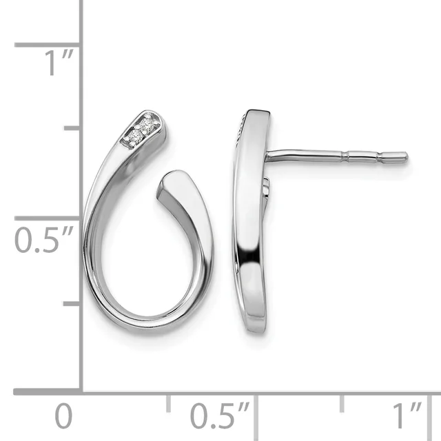 A pair of silver curved hoop earrings with diamond accents shown next to a measurement scale indicating approximately one inch in length.