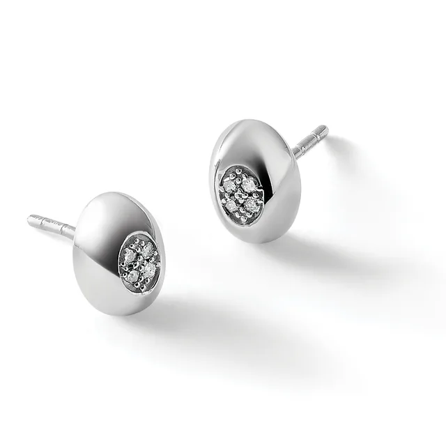 A pair of polished silver oval stud earrings, each featuring a cluster of small diamonds set in the center, shown with posts and backs.