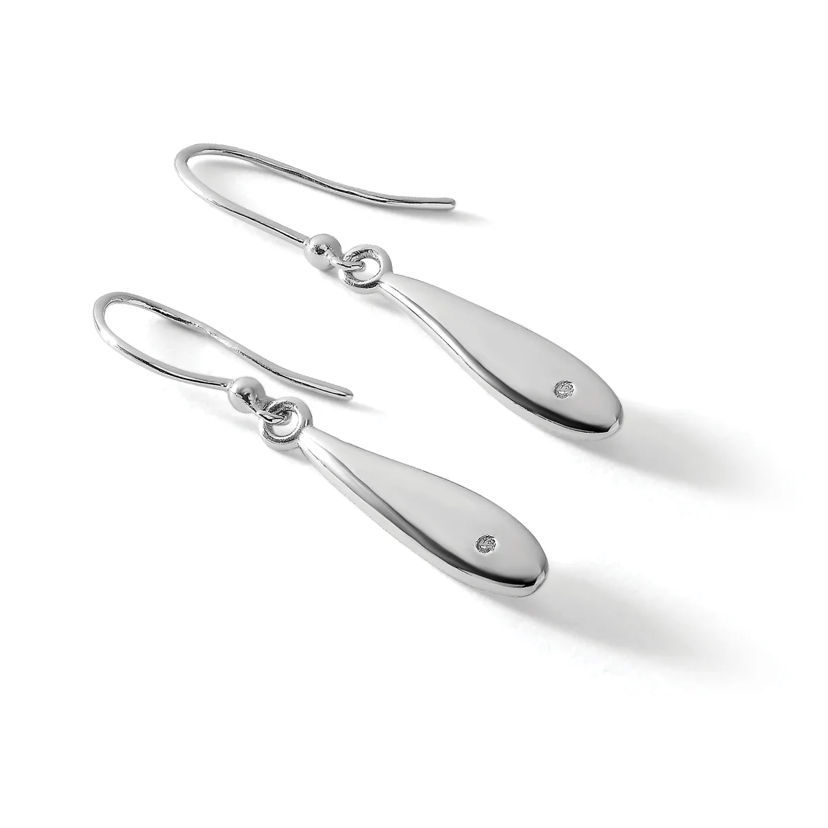 A pair of silver teardrop earrings with small diamond accents, suspended from curved wire hooks.
