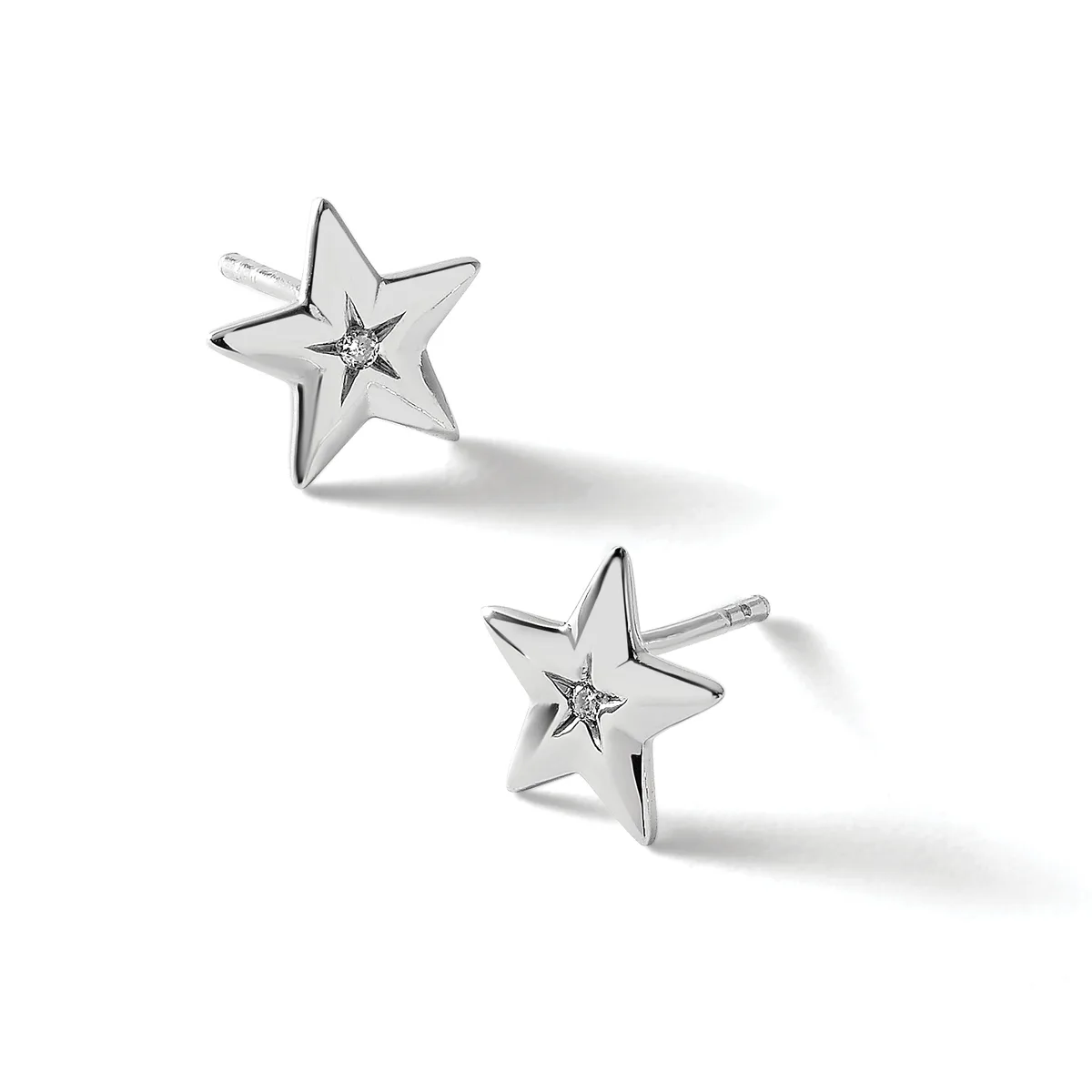 A pair of silver star-shaped stud earrings with small diamonds at the centers, shown from different angles against a white background.