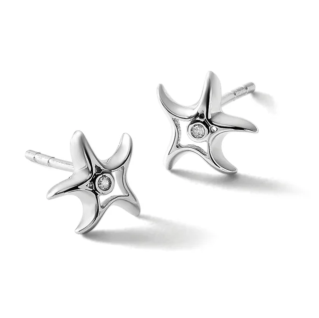 A pair of silver stud earrings with four-pointed star designs, each featuring a small diamond at the center, shown from two angles against a white background.