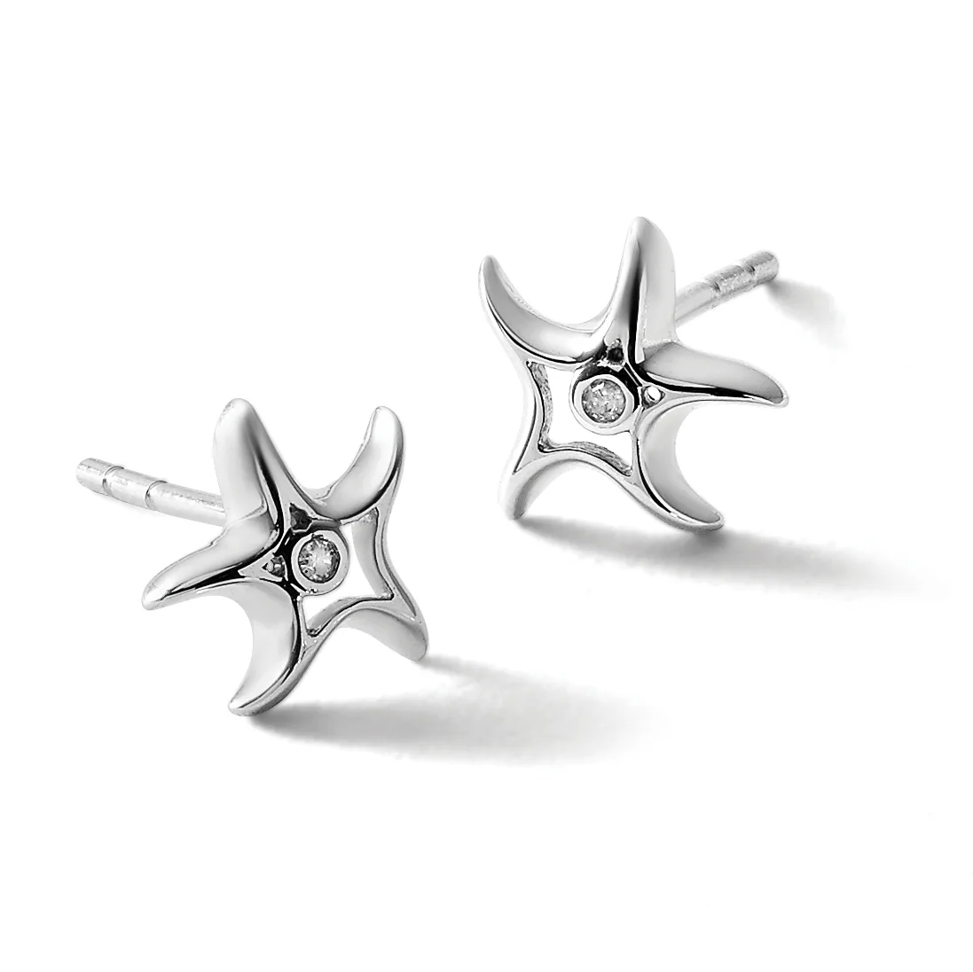 A pair of silver stud earrings with four-pointed star designs, each featuring a small diamond at the center, shown from two angles against a white background.