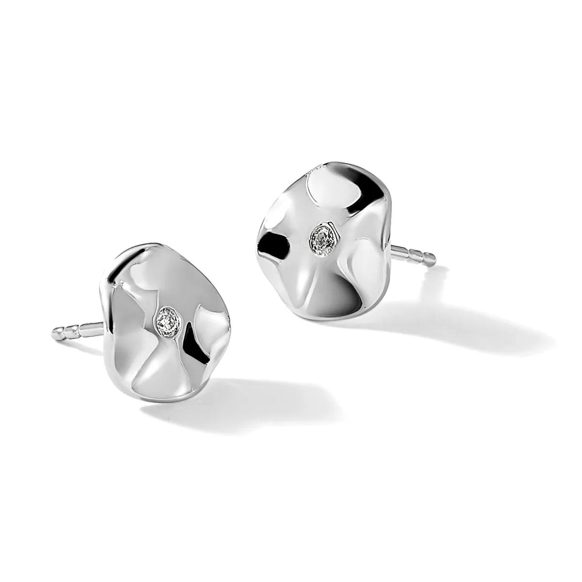 A pair of polished silver stud earrings with organic curved surfaces and small diamond accents, displayed against a white background.