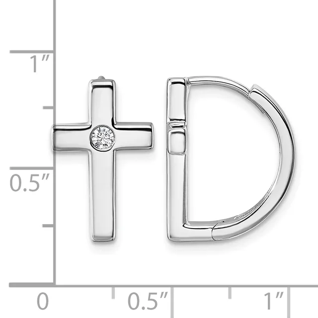 A pair of sterling silver earrings displayed against a measurement scale, consisting of a cross stud with a center diamond and a curved D-shaped hoop.