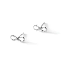 A pair of silver bow-shaped stud earrings with small diamonds or cubic zirconia stones at the center, displayed against a white background.