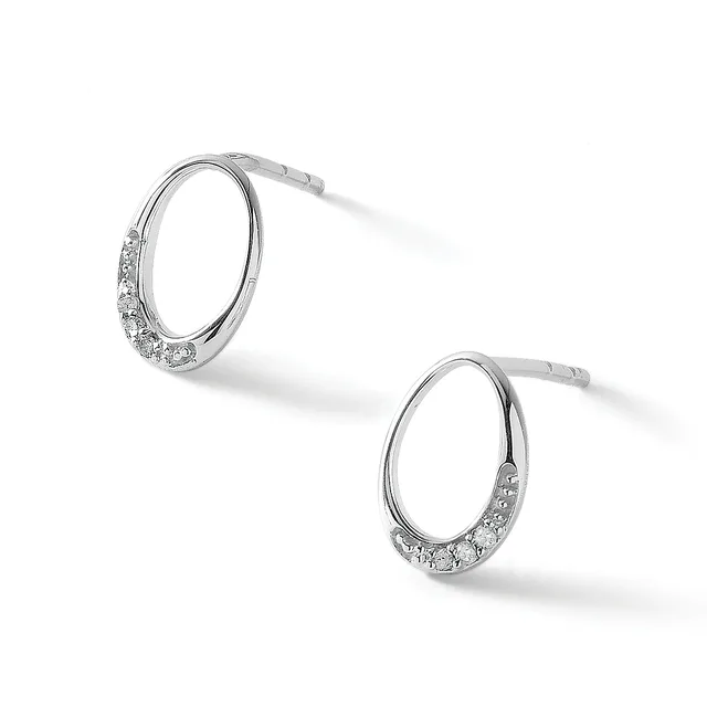 A pair of silver hoop earrings with cubic zirconia stones set along the lower portion of each hoop, shown at angles against a white background.