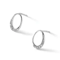 A pair of silver hoop earrings with cubic zirconia stones set along the lower portion of each hoop, shown at angles against a white background.