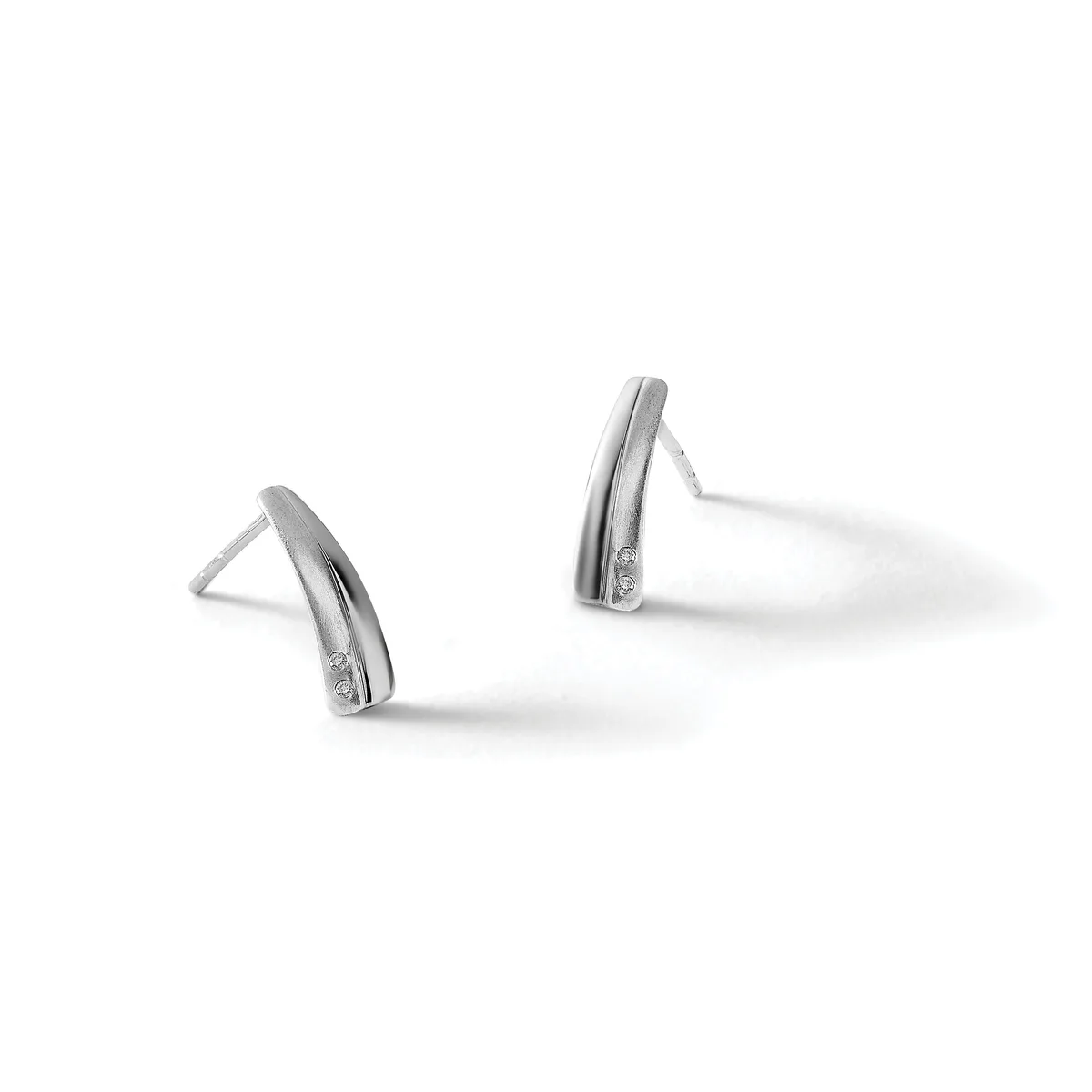 Pair of silver curved stud earrings with a polished finish and small stamped hallmark, shown against a white background.