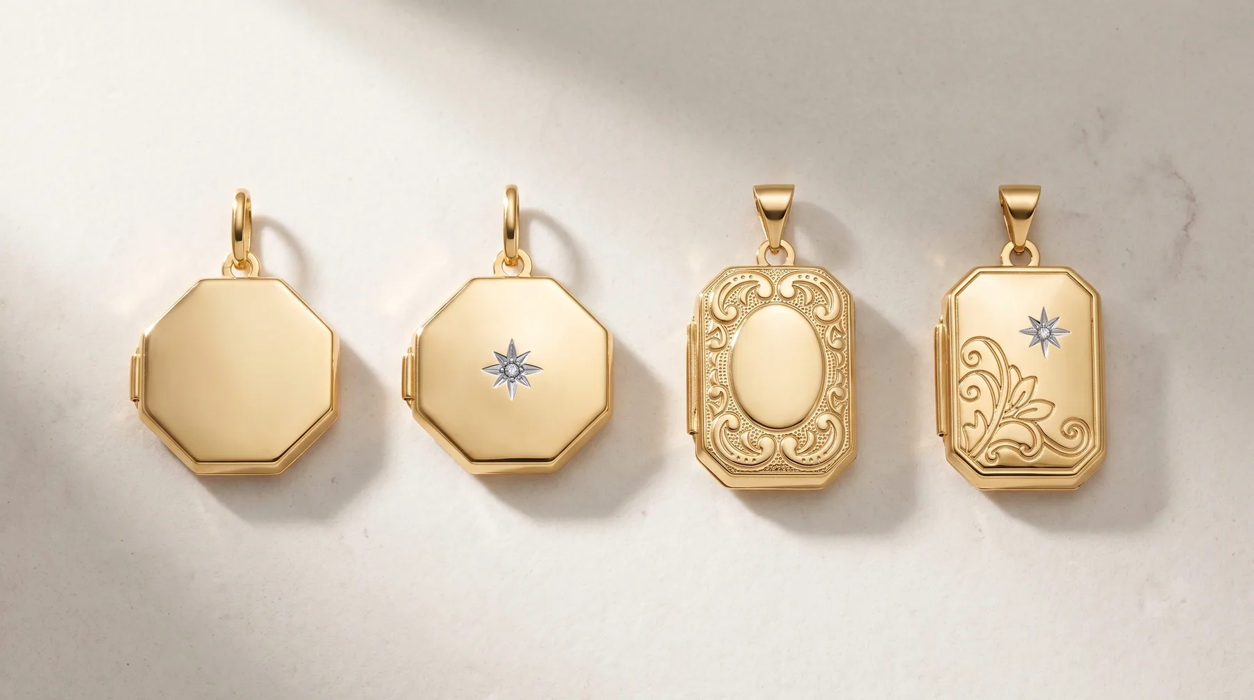Four gold locket pendants displayed in a row, featuring octagonal and rectangular shapes with plain and ornately engraved surfaces, some with small diamond accents.