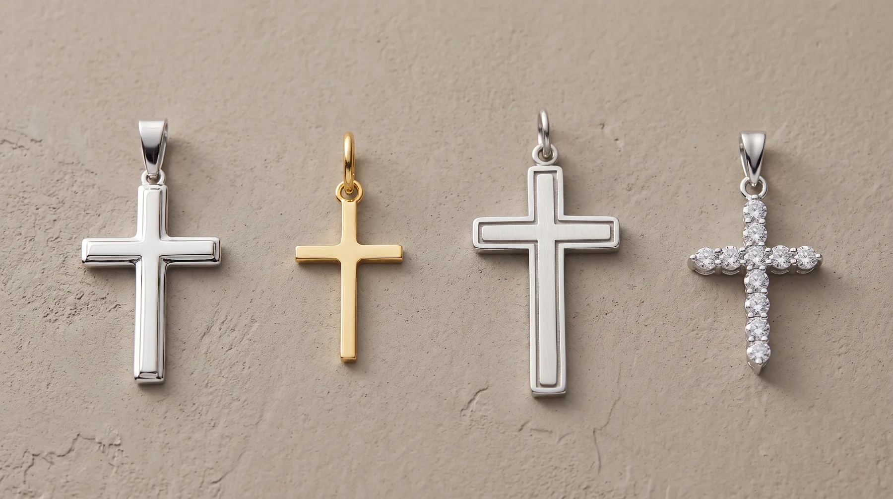 Four cross pendants in a row on a neutral background: silver plain cross, gold plain cross, silver cross with outline detail, and silver cross adorned with small crystals.